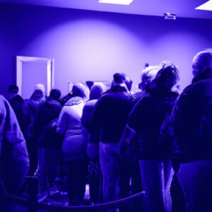 a queue of people waiting to enter a store